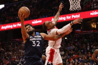 Dec 1, 2021; Washington, District of Columbia, USA; Minnesota Timberwolves center Karl-Anthony Towns (32) rebounds the ball in front of Washington Wizards center Daniel Gafford (21) during the third quarter at Capital One Arena. Mandatory Credit: Geoff Burke-USA TODAY Sports