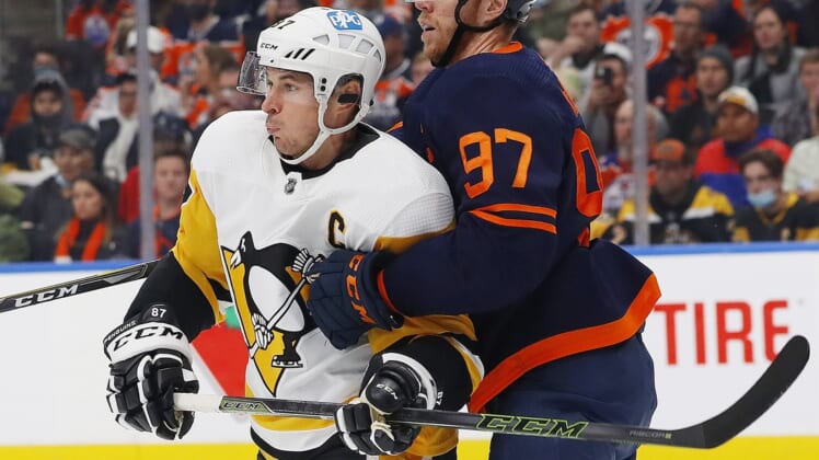 Dec 1, 2021; Edmonton, Alberta, CAN; Pittsburgh Penguins forward Sidney Crosby (87) and Edmonton Oilers forward Connor McDavid (97) battle for position during the second period at Rogers Place. Mandatory Credit: Perry Nelson-USA TODAY Sports