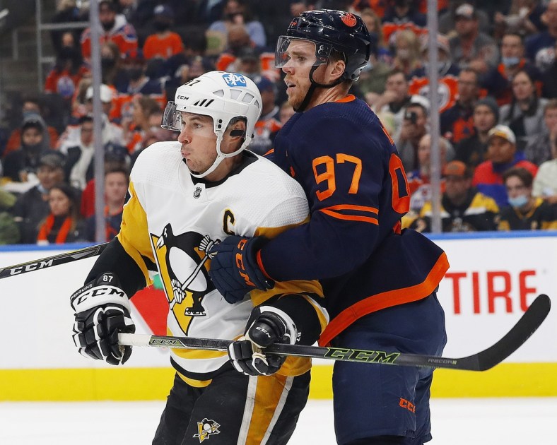 Dec 1, 2021; Edmonton, Alberta, CAN; Pittsburgh Penguins forward Sidney Crosby (87) and Edmonton Oilers forward Connor McDavid (97) battle for position during the second period at Rogers Place. Mandatory Credit: Perry Nelson-USA TODAY Sports