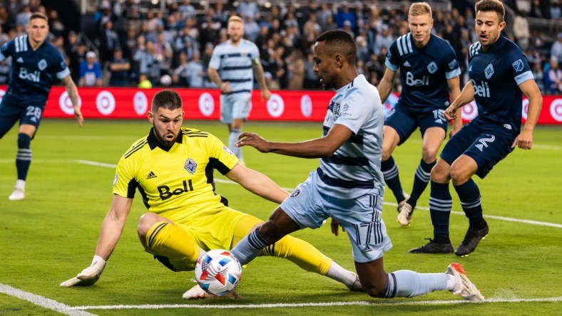 Nov 20, 2021; Kansas City, KS, USA; Sporting Kansas City midfielder Gadi Kinda (17) and Vancouver Whitecaps goalkeeper Maxime Crepeau (16) during the second half at Children's Mercy Park. Mandatory Credit: Jay Biggerstaff-USA TODAY Sports