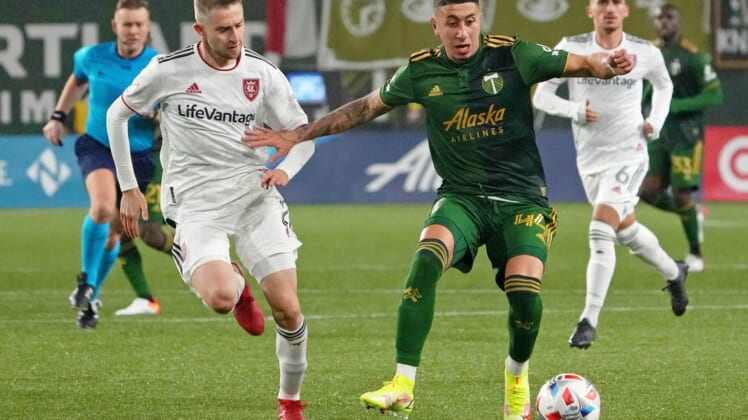 Dec 4, 2021; Portland, Oregon, USA; Portland Timbers midfielder Marvin Loria (44) dribbles the ball as Real Salt Lake defender Andrew Brody (2) gives chase during the second half during the Western Conference Finals of the 2021 MLS Playoffs at Providence Park. Mandatory Credit: Kirby Lee-USA TODAY Sports