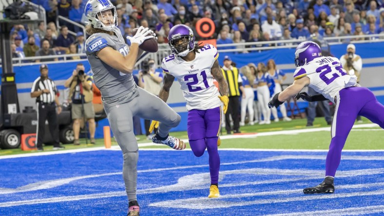 Dec 5, 2021; Detroit, Michigan, USA; Detroit Lions tight end T.J. Hockenson (88) catches a pass for a touch down in front of Minnesota Vikings cornerback Bashaud Breeland (21) at Ford Field. Mandatory Credit: David Reginek-USA TODAY Sports