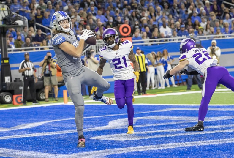 Dec 5, 2021; Detroit, Michigan, USA; Detroit Lions tight end T.J. Hockenson (88) catches a pass for a touch down in front of Minnesota Vikings cornerback Bashaud Breeland (21) at Ford Field. Mandatory Credit: David Reginek-USA TODAY Sports