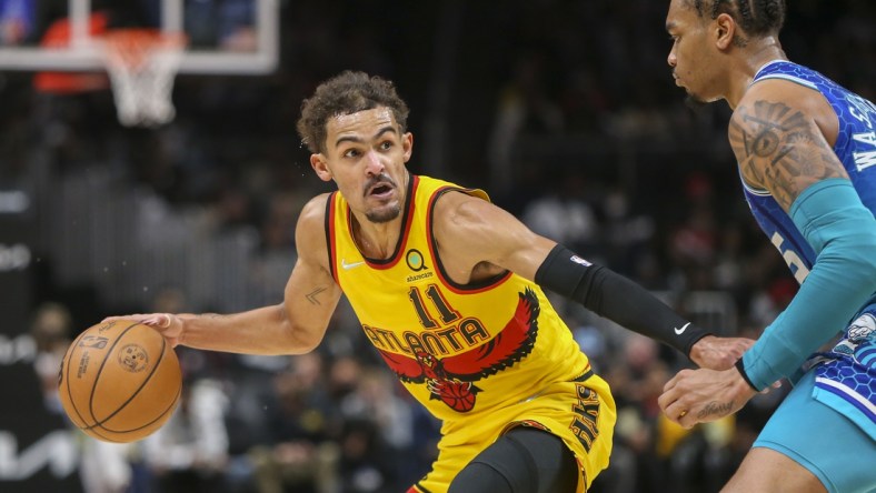 Dec 5, 2021; Atlanta, Georgia, USA; Atlanta Hawks guard Trae Young (11) dribbles the ball as Charlotte Hornets forward P.J. Washington (25) defends in the second half at State Farm Arena. Mandatory Credit: Brett Davis-USA TODAY Sports