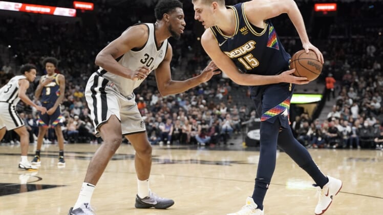 Dec 11, 2021; San Antonio, Texas, USA; Denver Nuggets center Nikola Jokic (15) prepares to drive to the basket while defended by San Antonio Spurs forward Thaddeus Young (30) during the second half at AT&T Center. Mandatory Credit: Scott Wachter-USA TODAY Sports