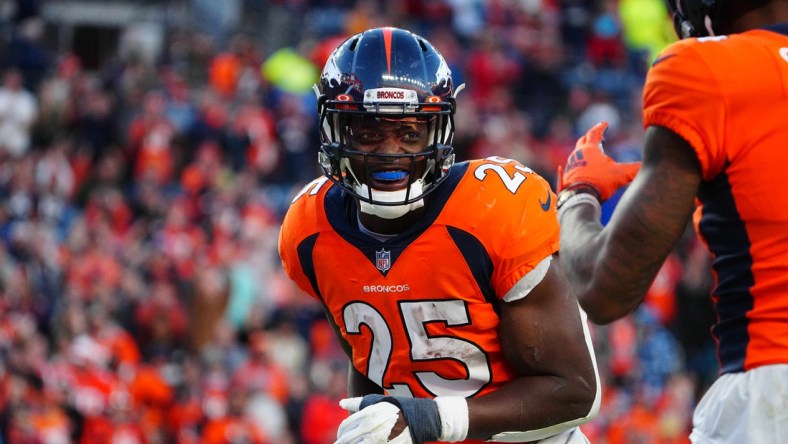 Dec 12, 2021; Denver, Colorado, USA; Denver Broncos running back Melvin Gordon III (25) reacts following his touchdown carry in the third quarter against the Detroit Lions at Empower Field at Mile High. Mandatory Credit: Ron Chenoy-USA TODAY Sports