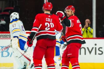 Dec 4, 2021; Raleigh, North Carolina, USA;  Carolina Hurricanes defenseman Ian Cole (28) is congratulated by  right wing Nino Niederreiter (21) after his goal against the Buffalo Sabres during the second period at PNC Arena. Mandatory Credit: James Guillory-USA TODAY Sports