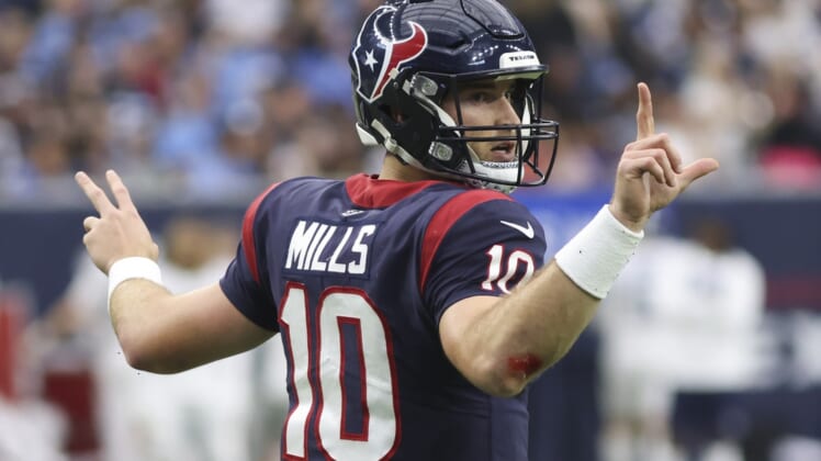 Jan 9, 2022; Houston, Texas, USA; Houston Texans quarterback Davis Mills (10) signals for the team to go for a two point conversion against the Tennessee Titans in the fourth quarter at NRG Stadium. Mandatory Credit: Thomas Shea-USA TODAY Sports