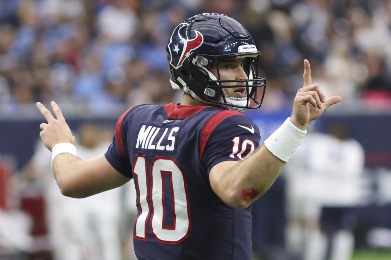 Jan 9, 2022; Houston, Texas, USA; Houston Texans quarterback Davis Mills (10) signals for the team to go for a two point conversion against the Tennessee Titans in the fourth quarter at NRG Stadium. Mandatory Credit: Thomas Shea-USA TODAY Sports