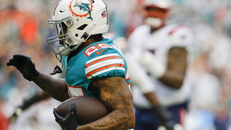 Jan 9, 2022; Miami Gardens, Florida, USA; Miami Dolphins cornerback Xavien Howard (25) runs with the football after intercepting the ball against the New England Patriots during the first quarter at Hard Rock Stadium. Mandatory Credit: Sam Navarro-USA TODAY Sports