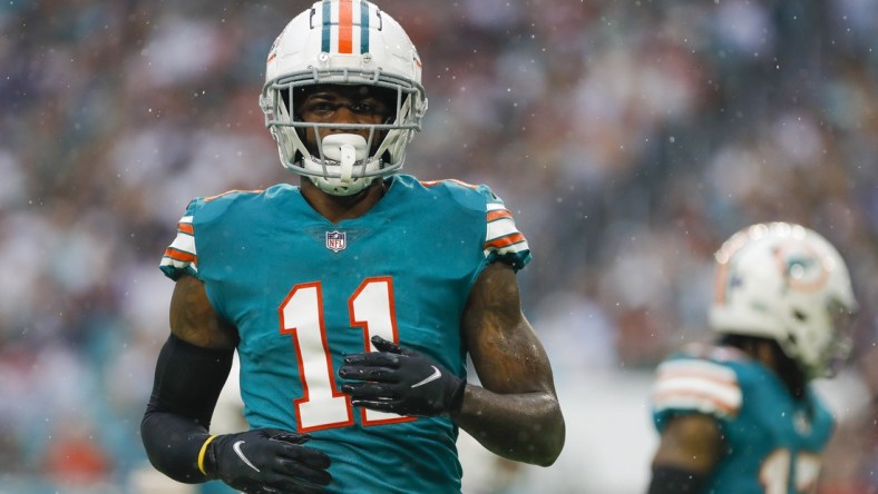 Jan 9, 2022; Miami Gardens, Florida, USA; Miami Dolphins wide receiver DeVante Parker (11) watches from the field during the second quarter of the game against the New England Patriots at Hard Rock Stadium. Mandatory Credit: Sam Navarro-USA TODAY Sports