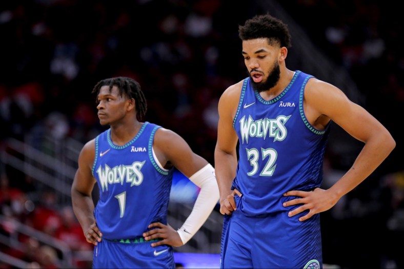 Jan 9, 2022; Houston, Texas, USA; Minnesota Timberwolves forward Anthony Edwards (1, left) and Minnesota Timberwolves center Karl-Anthony Towns (32) stand together during a break in the action against the Houston Rockets at Toyota Center. Mandatory Credit: Erik Williams-USA TODAY Sports