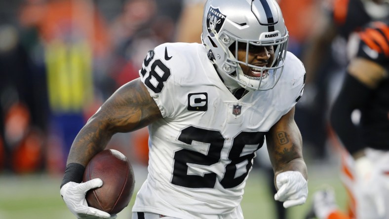 Jan 15, 2022; Cincinnati, Ohio, USA; Las Vegas Raiders running back Josh Jacobs (28) runs during the second quarter in an AFC Wild Card playoff football game against the Cincinnati Bengals at Paul Brown Stadium. Mandatory Credit: Joseph Maiorana-USA TODAY Sports