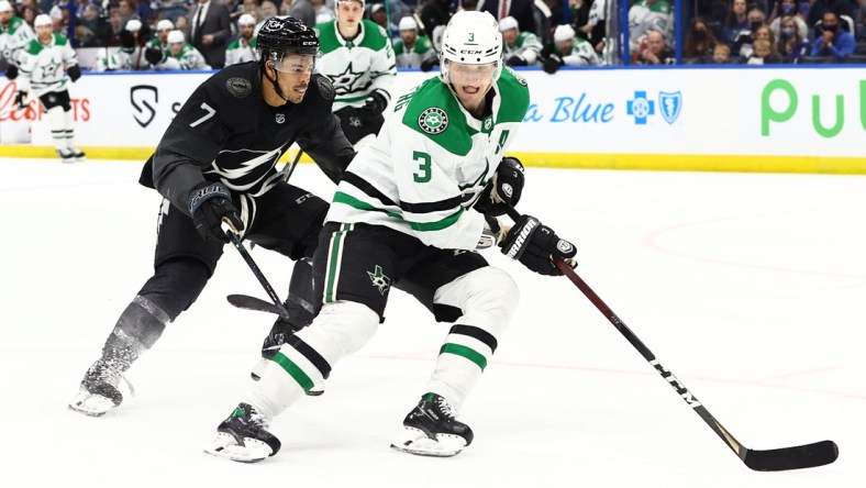 Jan 15, 2022; Tampa, Florida, USA;  Dallas Stars defenseman John Klingberg (3) skates with the puck as Tampa Bay Lightning right wing Mathieu Joseph (7) defends during the third period at Amalie Arena. Mandatory Credit: Kim Klement-USA TODAY Sports