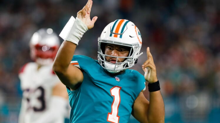 Jan 9, 2022; Miami Gardens, Florida, USA;Miami Dolphins quarterback Tua Tagovailoa (1) reacts after running with the football for a first down against the New England Patriots during the fourth quarter of the game at Hard Rock Stadium. Mandatory Credit: Sam Navarro-USA TODAY Sports