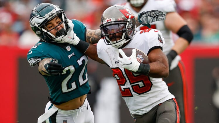 Jan 16, 2022; Tampa, Florida, USA; Tampa Bay Buccaneers running back Giovani Bernard (25) holds off Philadelphia Eagles free safety Marcus Epps (22) in the third quarter in a NFC Wild Card playoff football game at Raymond James Stadium. Mandatory Credit: Nathan Ray Seebeck-USA TODAY Sports
