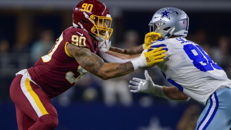 Dec 26, 2021; Arlington, Texas, USA; Washington Football Team defensive end Montez Sweat (90) and Dallas Cowboys tight end Dalton Schultz (86) in action during the game between the Washington Football Team and the Dallas Cowboys at AT&T Stadium. Mandatory Credit: Jerome Miron-USA TODAY Sports