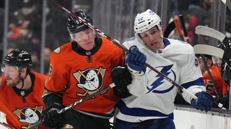 Jan 21, 2022; Anaheim, California, USA; Anaheim Ducks right wing Buddy Robinson (53) checks Tampa Bay Lightning defenseman Cal Foote (52) into the boards in the third period at Honda Center. Mandatory Credit: Kirby Lee-USA TODAY Sports