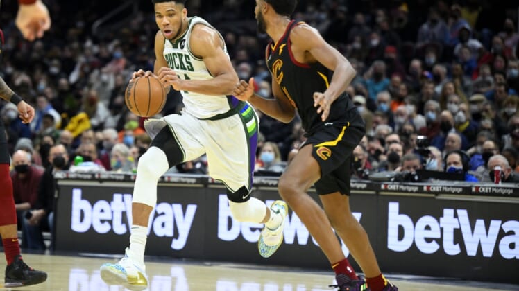 Jan 26, 2022; Cleveland, Ohio, USA; Milwaukee Bucks forward Giannis Antetokounmpo (34) drives against Cleveland Cavaliers center Evan Mobley (4) in the fourth quarter at Rocket Mortgage FieldHouse. Mandatory Credit: David Richard-USA TODAY Sports