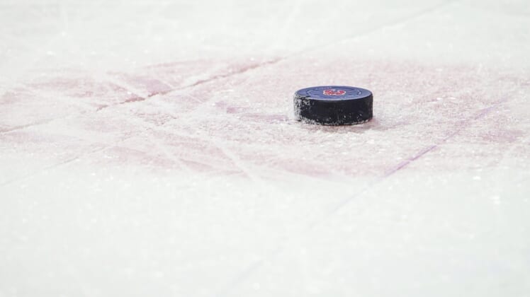 Jan 29, 2022; Calgary, Alberta, CAN; General view of the hockey puck during the third period between the Calgary Flames and the Vancouver Canucks at Scotiabank Saddledome. Mandatory Credit: Sergei Belski-USA TODAY Sports