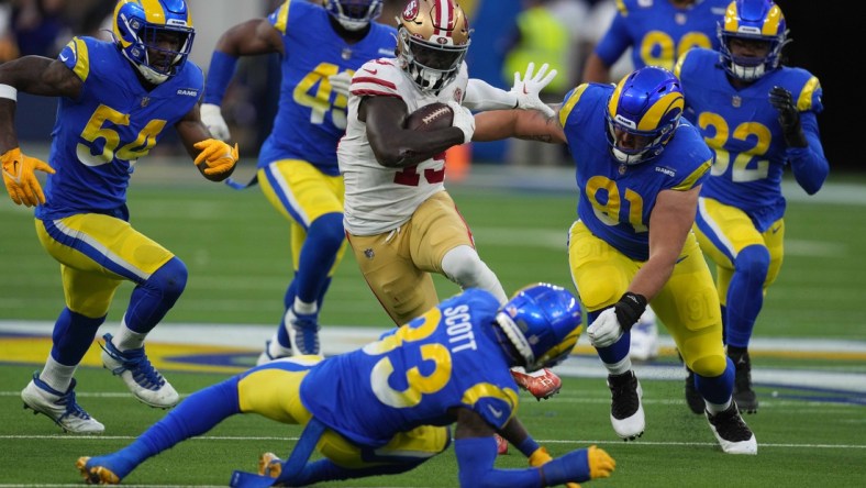 Jan 30, 2022; Inglewood, California, USA; San Francisco 49ers wide receiver Deebo Samuel (19) is pursued by Los Angeles Rams outside linebacker Leonard Floyd (54) and defensive end Earnest Brown IV (90) on a 44-yard touchdown reception in the second quarter during the NFC Championship game at SoFi Stadium. The Rams defeated the 49ers 20-17. Mandatory Credit: Kirby Lee-USA TODAY Sports