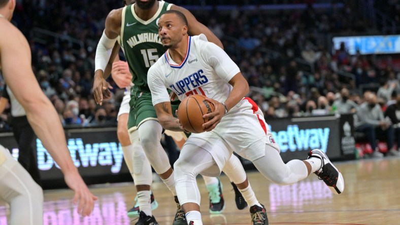 Feb 6, 2022; Los Angeles, California, USA;  Los Angeles Clippers forward Norman Powell (24) drives to the basket past Milwaukee Bucks guard Jeff Dowtin (15) in the second half at Crypto.com Arena. Mandatory Credit: Jayne Kamin-Oncea-USA TODAY Sports