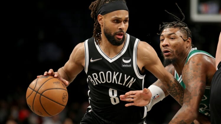Feb 8, 2022; Brooklyn, New York, USA; Brooklyn Nets guard Patty Mills (8) controls the ball against Boston Celtics guard Marcus Smart (36) during the first quarter at Barclays Center. Mandatory Credit: Brad Penner-USA TODAY Sports