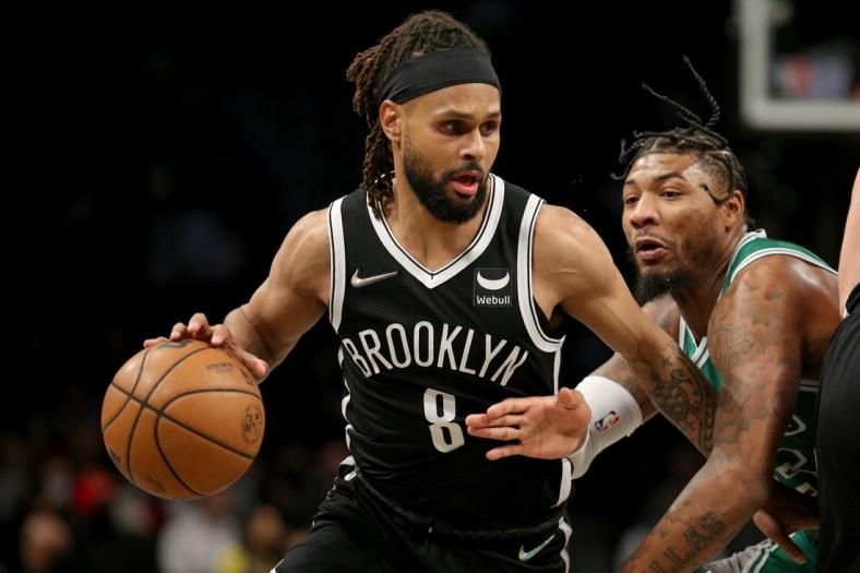 Feb 8, 2022; Brooklyn, New York, USA; Brooklyn Nets guard Patty Mills (8) controls the ball against Boston Celtics guard Marcus Smart (36) during the first quarter at Barclays Center. Mandatory Credit: Brad Penner-USA TODAY Sports