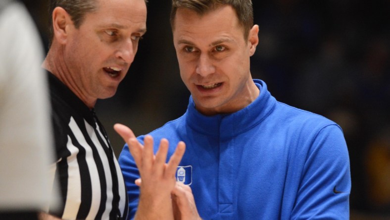 Feb 15, 2022; Durham, North Carolina, USA; Duke Blue Devils associate head coach Jon Scheyer (right) talks with and official during the second half at Cameron Indoor Stadium.  The Blue Devils won 76-74. Mandatory Credit: Rob Kinnan-USA TODAY Sports