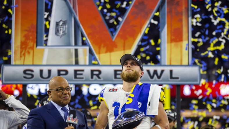 Feb 13, 2022; Inglewood, CA, USA; Los Angeles Rams wide receiver Cooper Kupp (10) holds the Lombardi Trophy as he is interviewed by NBC sports host Mike Tirico after defeating the Cincinnati Bengals during Super Bowl LVI at SoFi Stadium. Mandatory Credit: Mark J. Rebilas-USA TODAY Sports