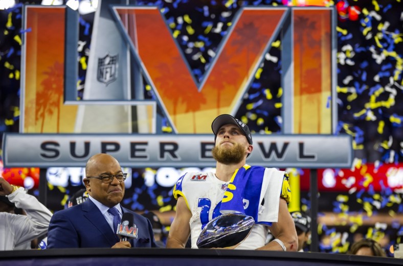 Feb 13, 2022; Inglewood, CA, USA; Los Angeles Rams wide receiver Cooper Kupp (10) holds the Lombardi Trophy as he is interviewed by NBC sports host Mike Tirico after defeating the Cincinnati Bengals during Super Bowl LVI at SoFi Stadium. Mandatory Credit: Mark J. Rebilas-USA TODAY Sports