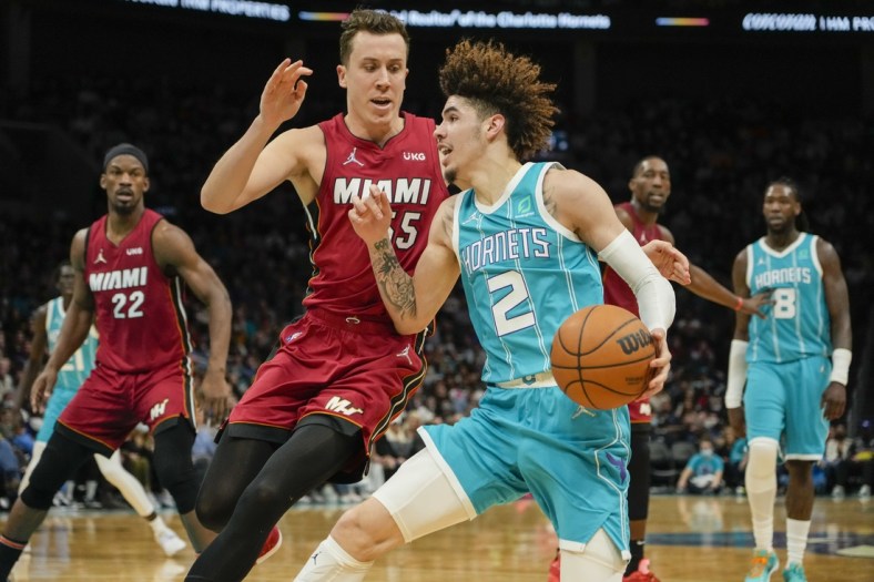 Feb 17, 2022; Charlotte, North Carolina, USA; Charlotte Hornets guard LaMelo Ball (2) drives to the basket defended by Miami Heat guard Duncan Robinson (55) during the second half at the Spectrum Center. Mandatory Credit: Jim Dedmon-USA TODAY Sports