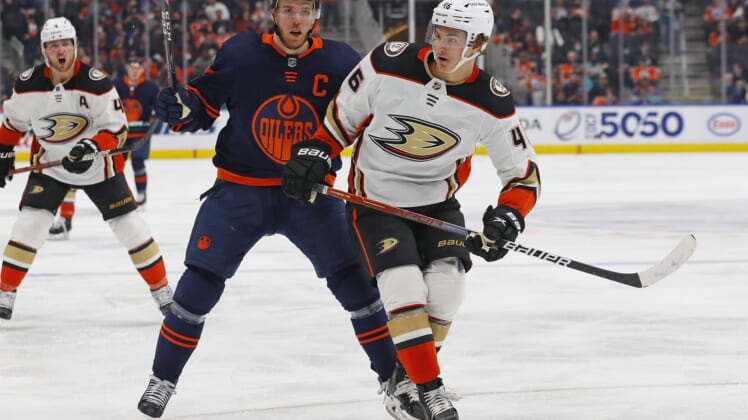 Feb 17, 2022; Edmonton, Alberta, CAN; Edmonton Oilers forward Connor McDavid (97) and Anaheim Ducks forward Trevor Zegras (46) chase a loose puck during the third period at Rogers Place. Mandatory Credit: Perry Nelson-USA TODAY Sports