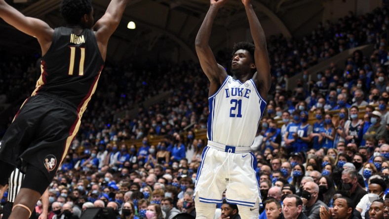 Feb 19, 2022; Durham, North Carolina, USA; Duke Blue Devils forward AJ Griffin (21) shoots over Florida State Seminoles center Tanor Ngom (11) during the second half at Cameron Indoor Stadium. Mandatory Credit: Rob Kinnan-USA TODAY Sports