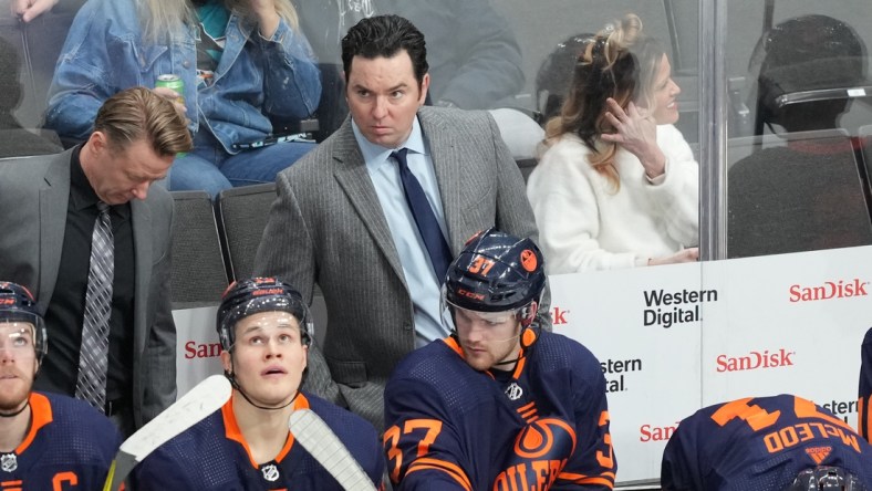 Feb 14, 2022; San Jose, California, USA; Edmonton Oilers head coach Jay Woodcroft stands behind the bench during the third period against the San Jose Sharks at SAP Center at San Jose. Mandatory Credit: Darren Yamashita-USA TODAY Sports