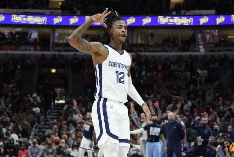 Feb 26, 2022; Chicago, Illinois, USA; Memphis Grizzlies guard Ja Morant (12) celebrates a three point basket against the Chicago Bulls during the first half at United Center. Mandatory Credit: David Banks-USA TODAY Sports
