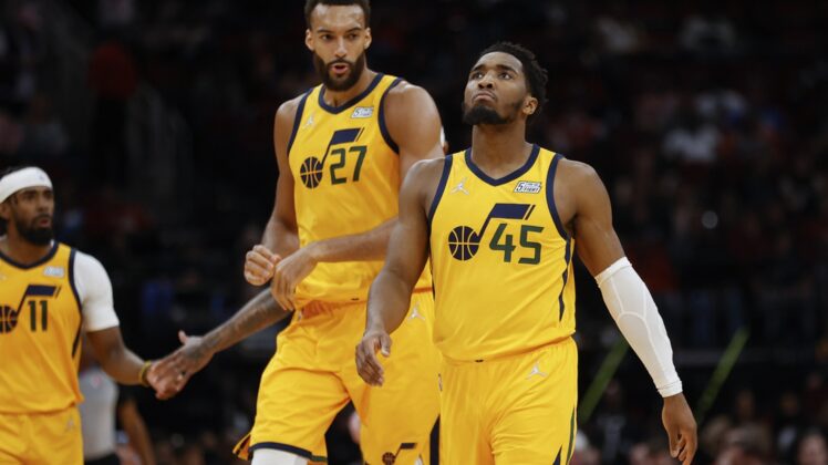 Mar 2, 2022; Houston, Texas, USA; Utah Jazz guard Donovan Mitchell (45) and center Rudy Gobert (27) react after a play during the third quarter against the Houston Rockets at Toyota Center. Mandatory Credit: Troy Taormina-USA TODAY Sports