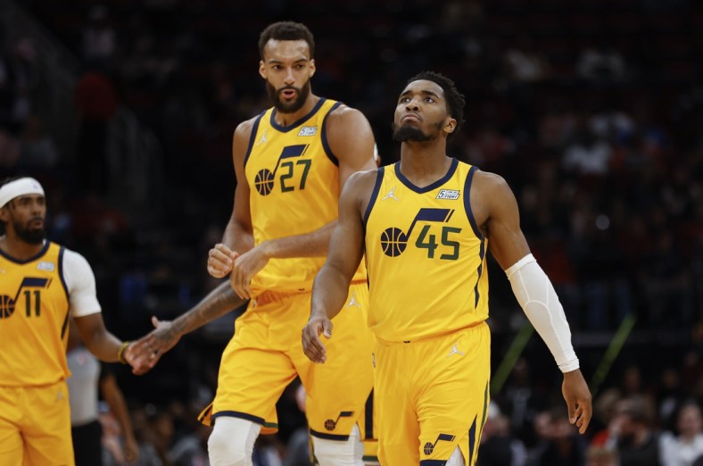 Mar 2, 2022; Houston, Texas, USA; Utah Jazz guard Donovan Mitchell (45) and center Rudy Gobert (27) react after a play during the third quarter against the Houston Rockets at Toyota Center. Mandatory Credit: Troy Taormina-USA TODAY Sports
