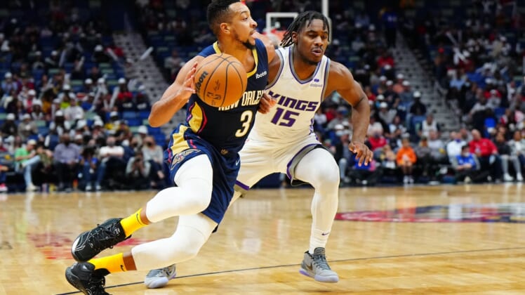 Mar 2, 2022; New Orleans, Louisiana, USA; New Orleans Pelicans guard CJ McCollum (3) drives to the basket against Sacramento Kings guard Davion Mitchell (15) during the third quarter at Smoothie King Center. Mandatory Credit: Andrew Wevers-USA TODAY Sports