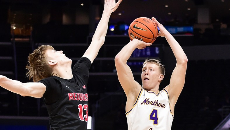 Mar 4, 2022; St. Louis, MO, USA;  Northern Iowa Panthers guard AJ Green (4) shoots as Illinois State Redbirds forward Liam McChesney (13) defends during the first half in the quarterfinals round of the Missouri Valley Conference Tournament at Enterprise Center. Mandatory Credit: Jeff Curry-USA TODAY Sports