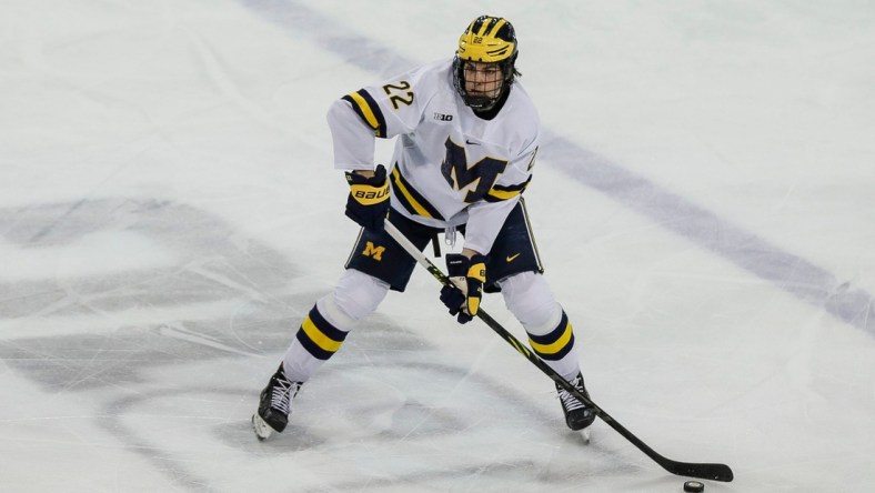 Michigan defenseman Owen Power (22) looks to pass against Michigan State during the third period in the first game of Big Ten quarterfinal at Yost Ice Arena in Ann Arbor on Friday, March 4, 2022.