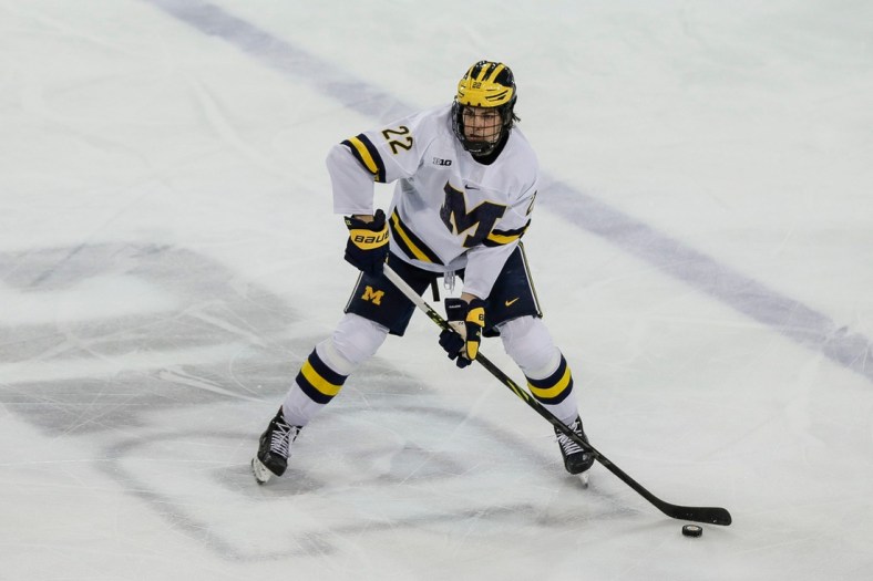 Michigan defenseman Owen Power (22) looks to pass against Michigan State during the third period in the first game of Big Ten quarterfinal at Yost Ice Arena in Ann Arbor on Friday, March 4, 2022.