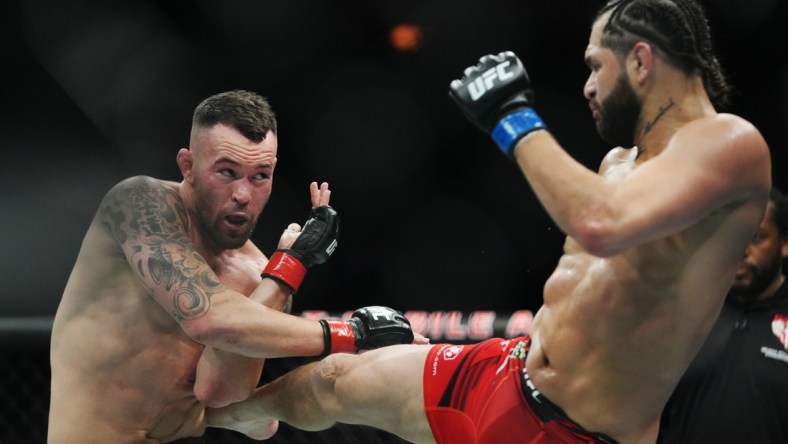 Mar 5, 2022; Las Vegas, Nevada, UNITED STATES; Colby Covington (red gloves) fights Jorge Masvidal (blue gloves) during UFC 272 at T-Mobile Arena. Mandatory Credit: Stephen R. Sylvanie-USA TODAY Sports