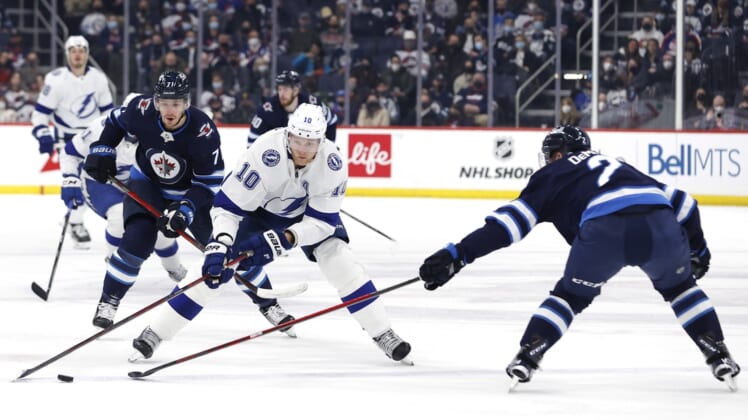 Mar 8, 2022; Winnipeg, Manitoba, CAN; Winnipeg Jets defenseman Dylan DeMelo (2) defends Tampa Bay Lightning right wing Corey Perry (10) in the first period at Canada Life Centre. Mandatory Credit: James Carey Lauder-USA TODAY Sports