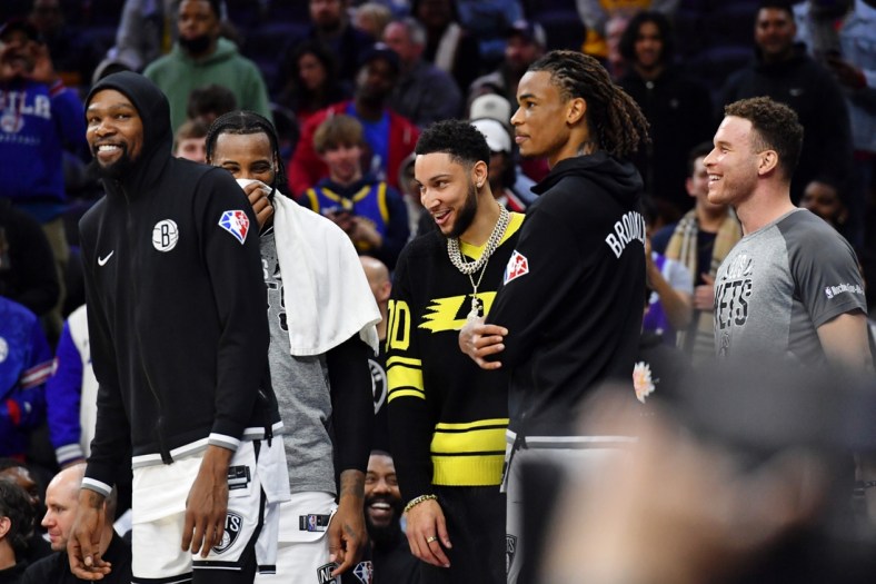 Mar 10, 2022; Philadelphia, Pennsylvania, USA; Brooklyn Nets forward Kevin Durant (7) and guard Ben Simmons (10) on the bench late in the fourth quarter of win against the Philadelphia 76ers at Wells Fargo Center. Mandatory Credit: Eric Hartline-USA TODAY Sports