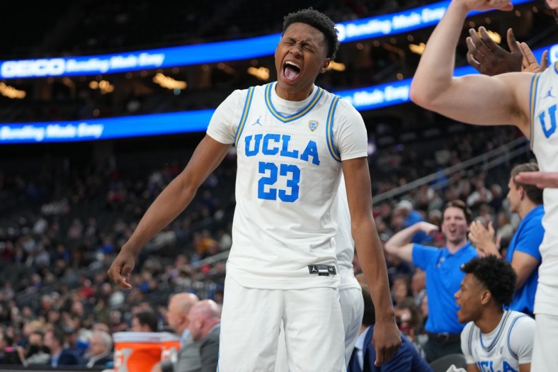 Mar 11, 2022; Las Vegas, NV, USA; UCLA Bruins guard Peyton Watson (23) celebrates on the bench after the Bruins scored against the USC Trojans during the second half at T-Mobile Arena. Mandatory Credit: Stephen R. Sylvanie-USA TODAY Sports