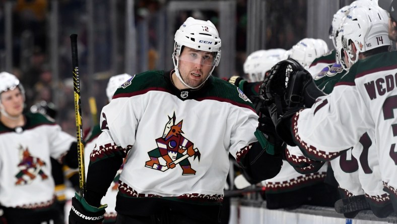 Mar 12, 2022; Boston, Massachusetts, USA; Arizona Coyotes left wing Nick Ritchie (12) celebrates with his teammates after scoring a goal Boston Bruins during the third period at the TD Garden. Mandatory Credit: Brian Fluharty-USA TODAY Sports