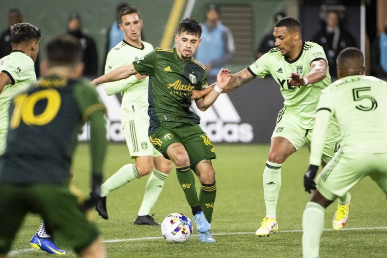 Mar 12, 2022; Portland, Oregon, USA; Austin FC defender Ruben Gabrielsen (4) defends Portland Timbers forward Diego Gutierrez (16) during the second half at Providence Park. The Timbers won the game 1-0. Mandatory Credit: Troy Wayrynen-USA TODAY Sports