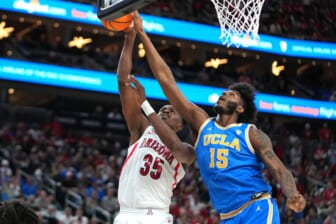 Mar 12, 2022; Las Vegas, NV, USA; UCLA Bruins center Myles Johnson (15) defends against a shot attempt by Arizona Wildcats center Christian Koloko (35) during the second half at T-Mobile Arena. Mandatory Credit: Stephen R. Sylvanie-USA TODAY Sports