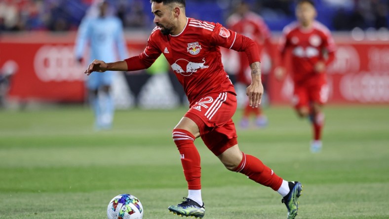 Mar 13, 2022; Harrison, New Jersey, USA; New York Red Bulls midfielder Luquinhas (82) dribbles the ball against Minnesota United during the second half at Red Bull Arena. Mandatory Credit: Vincent Carchietta-USA TODAY Sports